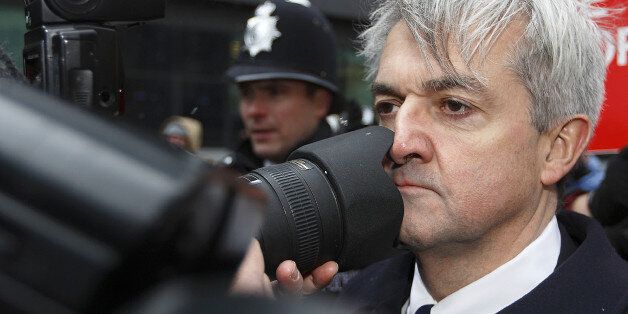 Former British energy minister Chris Huhne (R) comes into contact with a photographers lens as he arrives at Southwark Crown Court in London, on March 11, 2013. Huhne and his ex-wife Vicky Pryce are due to be sentenced later Monday for perverting the course of justice over speeding points a decade ago. AFP PHOTO / JUSTIN TALLIS (Photo credit should read JUSTIN TALLIS/AFP/Getty Images)