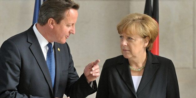 British prime minister David Cameron (left) and German chancellor Angela Merkel pictured during festive commemoration of the World War 1 victims in Ypres, Belgium on June 26, 2014. EU leaders commence June summit in Ypres. (CTK Photo/Jakub Dospiva)