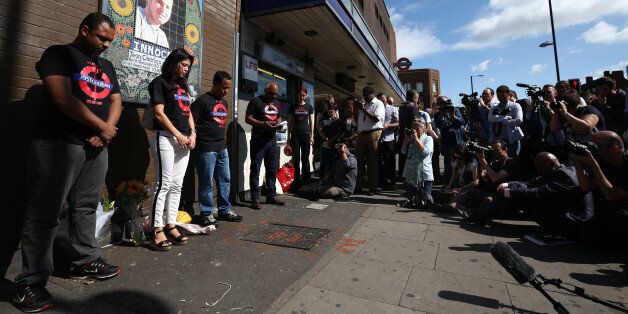LONDON, ENGLAND - JULY 22: Erionaldo Da Silva (L), Vivian Figueiredo (1-L) and Alessandro Pereira (2-L), cousins of Brazilian national Jean Charles de Menezes, hold a one minute silence during a memorial to mark the 10th anniversary of his death on July 22, 2015 at Stockwell underground station in London, England. Jean Charles de Menezes was fatally shot by police officers at Stockwell Station on the London Underground after he was wrongly identified as one of the fugitives involved in a previous failed bombing attempt. (Photo by Carl Court/Getty Images)