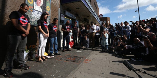 LONDON, ENGLAND - JULY 22: Erionaldo Da Silva (L), Vivian Figueiredo (1-L) and Alessandro Pereira (2-L), cousins of Brazilian national Jean Charles de Menezes, hold a one minute silence during a memorial to mark the 10th anniversary of his death on July 22, 2015 at Stockwell underground station in London, England. Jean Charles de Menezes was fatally shot by police officers at Stockwell Station on the London Underground after he was wrongly identified as one of the fugitives involved in a previous failed bombing attempt. (Photo by Carl Court/Getty Images)