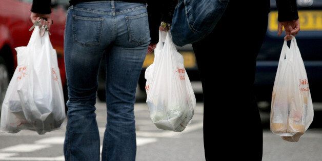 File photo dated 27/09/06 of people carrying plastic bags as the number of single-use plastic bags handed out by UK supermarkets has increased for the fifth year, running to 8.5 billion, figures show.