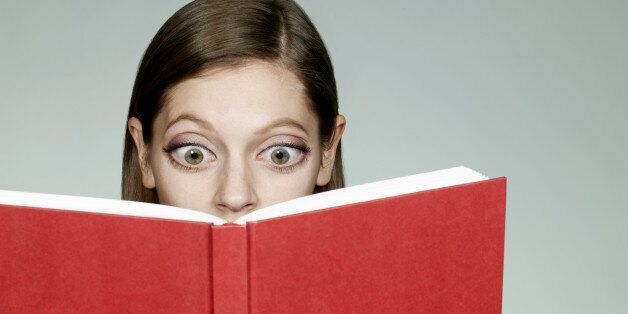 Woman with big eyes reading book