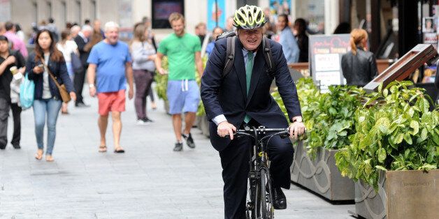 LONDON, ENGLAND - JULY 08: Boris Johnson rides his bicycle outside Global House on July 8, 2015 in London, England. (Photo by SAV/GC Images)