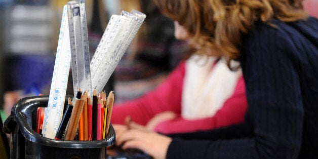 A generic stock photo shows Primary School children at work in a classroom.