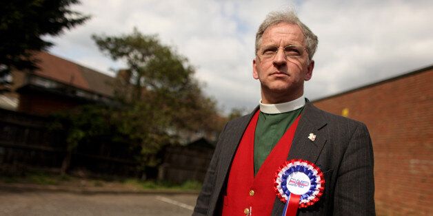 DAGENHAM, ENGLAND - APRIL 10: Reverend Robert West, the British National Party candidate for the parliamentary seat of Lincoln, wears a BNP rosette as he assists Nick Griffin, his party leader, in canvassing for support in Dagenham on April 10, 2010 in London, England. Mr Griffin is attempting to unseat the Labour MP Margaret Hodge in the constituency of Barking and Dagenham. (Photo by Oli Scarff/Getty Images)