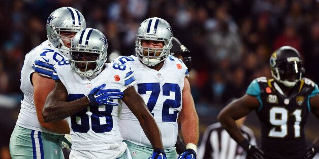Dallas Cowboys wide receiver Dez Bryant (88) celebrates his touchdown against the Jacksonville Jaguars with guard Zack Martin (70) and center Travis Frederick (72) as defensive end Chris Clemons (91) looks on during the first half of an NFL football game at Wembley Stadium, London, Sunday, Nov. 9, 2014. (AP Photo/Tim Ireland)