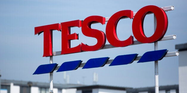 A Tesco logo stands on display outside a Tesco supermarket, operated by Tesco Plc, in London, U.K., on Monday, April 20, 2015. Tesco's April 22 results will serve as a reminder of the scale of the task still facing new Chief Executive Officer Dave Lewis after his decision to close dozens of stores, cancel some openings, consolidate head offices and cut prices on hundreds of branded goods. Photographer: Jason Alden/Bloomberg via Getty Images