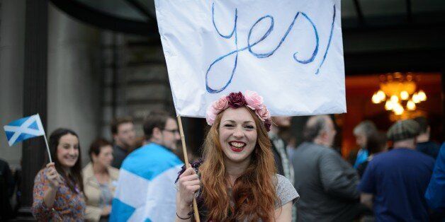 'Yes' campaign supporter waves a flag outside Usher Hall ahead of the 'A Night for Scotland' concert in Edinburgh, Scotland on September 14, 2014. Campaigners for and against Scottish independence raced to win over undecided voters ahead of Thursday's historic referendum, as religious leaders prayed for harmony and music fans gathered for a separatist concert. The Church of Scotland's moderator John Chalmers called for Scots to 'live in harmony with one another' whatever the result and hailed th