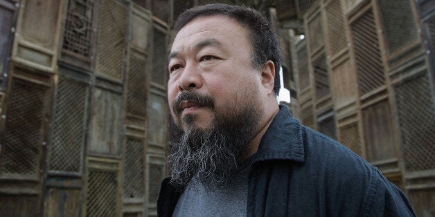 KASSEL, GERMANY - JUNE 13 Chinese Artist Ai Weiwei poses in front of his sculpture 'Template' during a media preview of Documenta 12 on June 13, 2007 in Kassel, Germany. The Documenta is 'one of the most important exhibitions of modern and contemporary art' which now takes place every five years in Kassel and will be open to the public June 16 - September 23. (Photo by Johannes Simon/Getty Images)