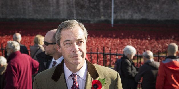 LONDON, ENGLAND - NOVEMBER 04: United Kingdom Independence Party (UKIP) leader, Nigel Farage, views the 'Blood Swept Lands and Seas of Red' installation at Tower of London on November 4, 2014 in London, England. 'Blood Swept Lands and Seas of Red' by artist Paul Cummins, made up of 888,246 ceramic poppies fills the moat of the Tower of London, to commemorate the First World War. Each ceramic poppy represents an allied victim of the First World War and the display is due to be completed by Arm