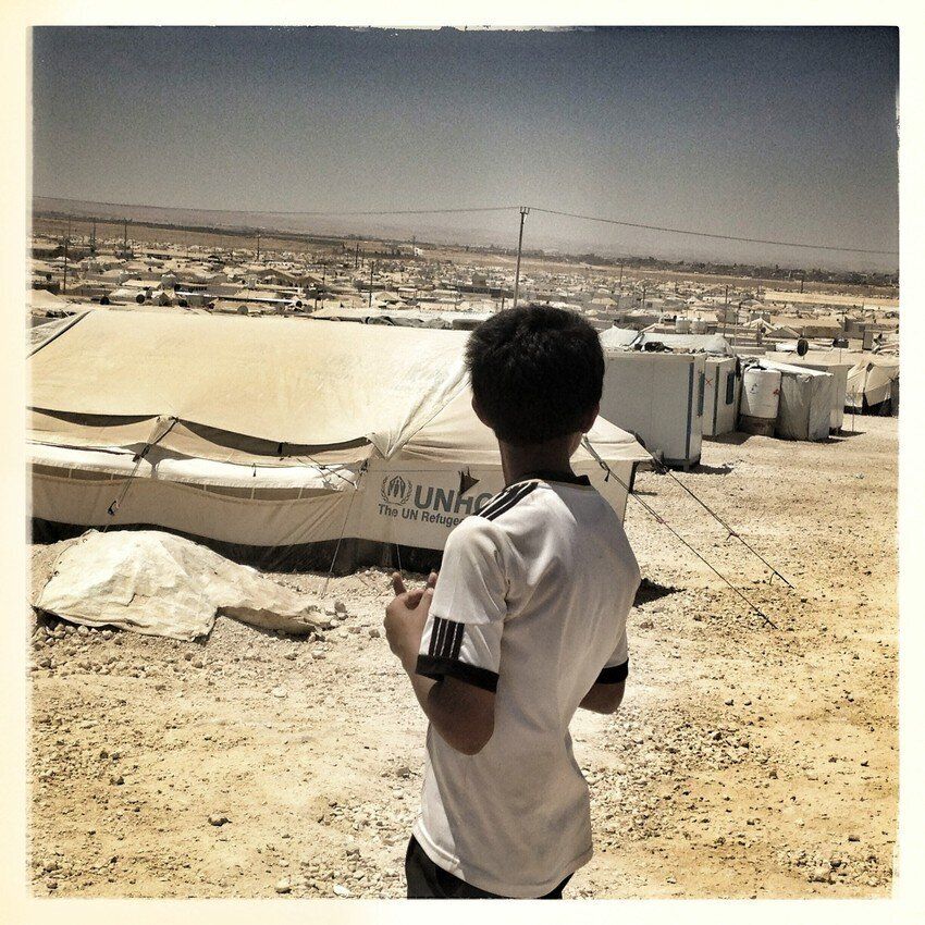 A young boy looks out over Za'atari