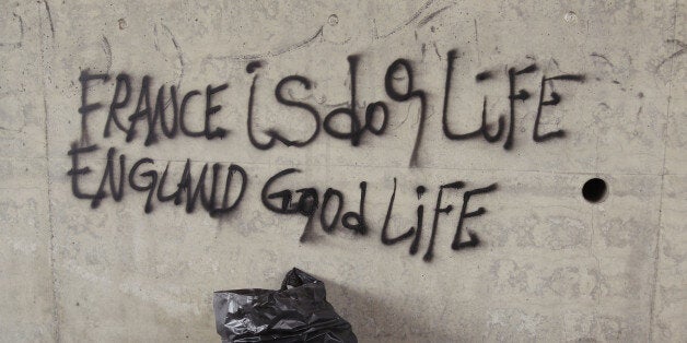 Graffiti on the walls of an underpass read