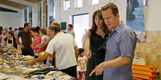 Prime Minister David Cameron and his wife Samantha look at fish in the market of Aljezur, on the southwestern coast of Portugal in 2013