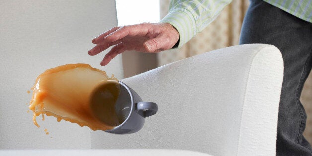 tea splashing out of mug onto chair