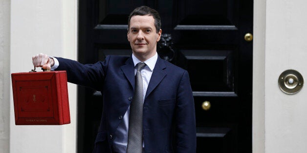 Chancellor of the Exchequer George Osborne poses for the media with the traditional red dispatch box outside his official residence at 11 Downing Street in London, Wednesday, March 18, 2015. The Chancellor is to deliver his annual budget speech to the House of Commons later Wednesday. (AP Photo/Kirsty Wigglesworth)