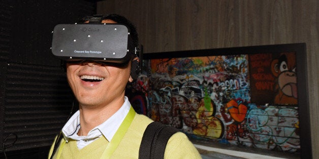 LAS VEGAS, NV - JANUARY 08: Bin Li of China tries out the Oculus VR Crescent Bay Headset prototype at the 2015 International CES at the Las Vegas Convention Center on January 8, 2015 in Las Vegas, Nevada. The immersive, virtual reality headset is meant to be a consumer version of the Oculus Rift and features 360-degree head tracking and high-quality integrated audio. CES, the world's largest annual consumer technology trade show, runs through January 9 and is expected to feature 3,600 exhibitors showing off their latest products and services to about 150,000 attendees. (Photo by Ethan Miller/Getty Images)