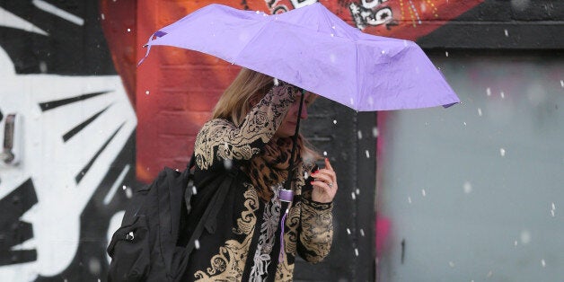 A woman runs for cover during a hailstone shower on May 19, 2015 in London, England. (Photo by Peter Macdiarmid/Getty Images)