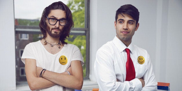 Two men in an office folding their arms