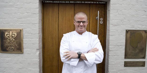 British Chef Heston Blumenthal is pictured at the entrance to the Fat Duck restaurant in Bray, Berkshire, on March 12, 2009. One of the world's finest restaurants, the Fat Duck, is to reopen Thursday, a spokeswoman for British chef Heston Blumenthal told AFP, two weeks after a health scare which hit some 400 diners. The Michelin three starred restaurant in Bray, west of London, closed on February 24 after about 40 customers said they had fallen ill, a figure which rose roughly tenfold following media coverage. AFP PHOTO/Ben Stansall (Photo credit should read BEN STANSALL/AFP/Getty Images)