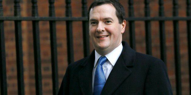 Britain's Chancellor George Osborne smiles as he walks across Downing Street in London, Wednesday, Jan. 8, 2014. (AP Photo/Kirsty Wigglesworth)