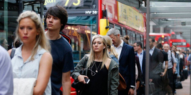 People queue up for bus transport at Victoria Station in London, Thursday, Aug. 6, 2015. A 24-hour strike of London tube workers continues over pay and conditions surrounding the planned introduction of overnight tube services. The Underground handles 4 million journeys a day, and the strike by members of four unions will likely paralyze the capital's transport system, despite extra bus and river services. (AP Photo/Frank Augstein)