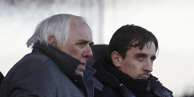 Neville Neville (left) and Gary Neville (right) watch in the stands