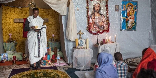 CALAIS, FRANCE - AUGUST 02: Kibrom Kasta leads an Orthodox service for Ethiopian and Eritrean worshippers at a church in a make shift camp near the port of Calais on August 2, 2015 in Calais, France. Hundreds of migrants are continuing to attempt to enter the Channel Tunnel and onto trains heading to the United Kingdom. (Photo by Rob Stothard/Getty Images)