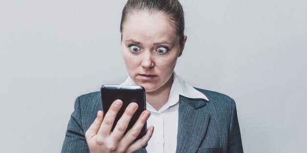 Businesswoman making big eyes while looking surprised.