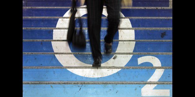 Berlin, GERMANY: A man walks down stairs covered in an ad for British mobile network operator O2 in Berlin 19 April 2007. AFP PHOTO JOHN MACDOUGALL (Photo credit should read JOHN MACDOUGALL/AFP/Getty Images)