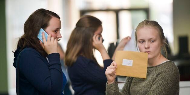 Students at Yate International Academy, South Gloucestershire, open their A-Level exam results, as official figures show that more A-levels were handed the very highest grade this summer, but the overall pass rate fell for the first time in more than 30 years.