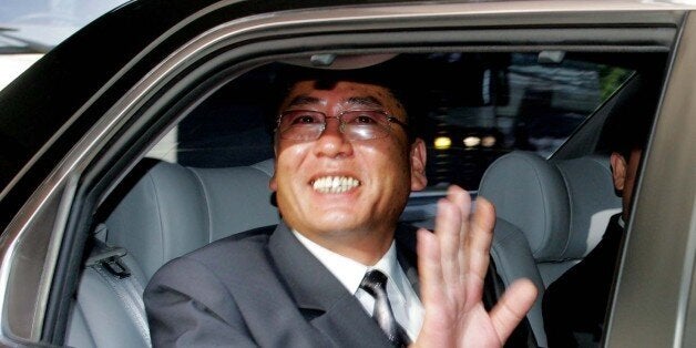 The head of North Korean delegation, Choe Yong-gon, deputy minister of construction and building material industries, waves as he leaves to North Korea after the inter-Korean economic talks in Seoul Tuesday, July 12, 2005. South Korea agreed Tuesday to provide North Korea with 500,000 tons in rice aid as the countries vowed to boost economic ties after the North announced it would end its boycott of nuclear disarmament talks. (AP Photo /You Sung-Ho, POOL)