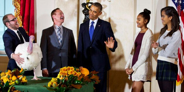 President Barack Obama gestures that his daughters Sasha, second from right, and Malia, right, would rather pass on touching