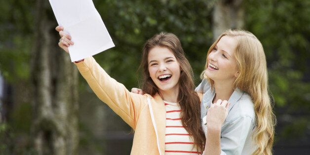 Two Teenage Girls Celebrating Successful Exam Results Smiling