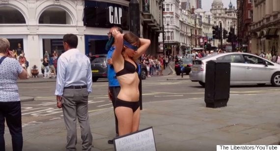 Woman Wearing Nothing But Underwear And Blindfold Stands In