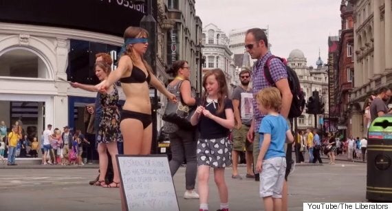 Woman Wearing Nothing But Underwear And Blindfold Stands In