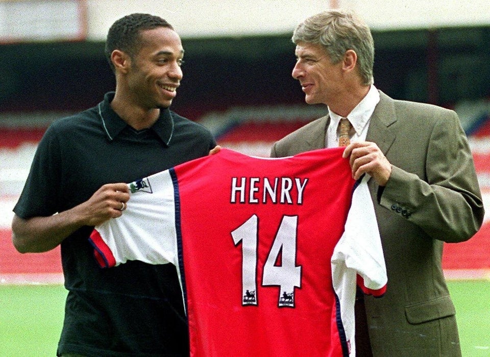 Striker Thierry Henry (L) holds up his shirt with