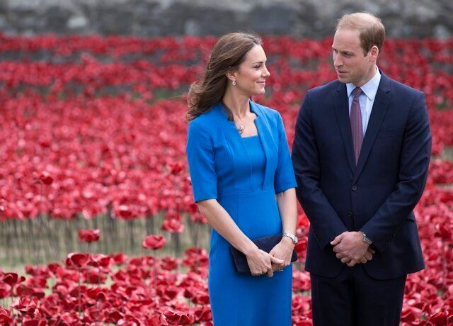 LONDON, ENGLAND - AUGUST 05: Catherine, Duchess of Cambridge and Prince William, Duke of Cambridge walk through an installation entitled 'Blood Swept Lands and Seas of Red' by artist Paul Cummins, made up of 888,246 ceramic poppies in the moat of the Tower of London, to commemorate the First World War on August 5, 2014 in London, England. Each ceramic poppy represents an allied victim of the First World War and the display is due to be completed by Armistice Day on November 11, 2014. After Armistice Day each poppy from the installation will be available to buy for 25 GBP. (Photo by Oli Scarff/Getty Images)