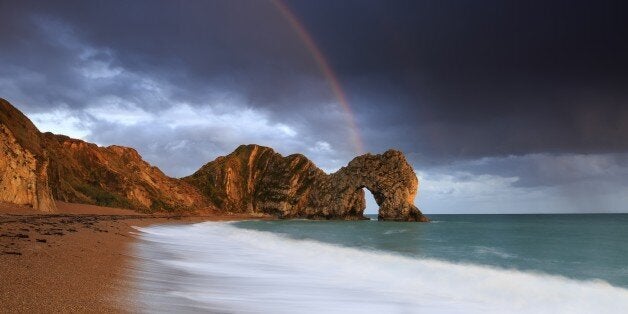 A rainbow over Durdle Door in Dorset. (Photo by: Loop Images/UIG via Getty Images)