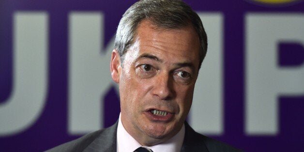 UK Independence Party (UKIP) party leader Nigel Farage speaks to a journalist in Rochester, Kent on November 21, 2014, a day after the party won a second seat in Parliament in a by-election. Mark Reckless was re-elected with 42 percent of the vote in Rochester and Strood in southeast England, after defecting in September from Prime Minister David Cameron's Conservative Party to UKIP, which wants strict quotas on immigration. AFP PHOTO / BEN STANSALL (Photo credit should read BEN STANSALL