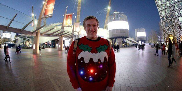 A music fan with a Christmas pudding jumper arrives for the Capital FM Jingle Bell Ball 2014 held at The O2 Arena, London