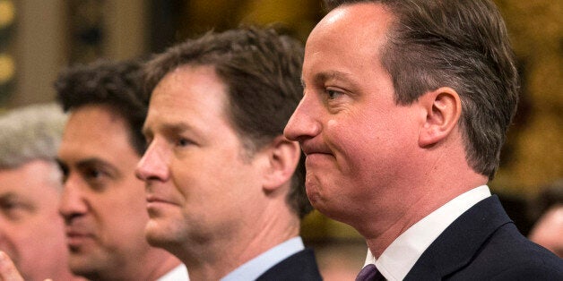 British Prime Minister, David Cameron (R), Britain's Deputy Prime Minister, Nick Clegg (2nd R) and British opposition Labour Party leader, Ed Miliband (L), react while listening to German Chancellor Angela Merkel's address to both Houses of Parliament in the Royal Gallery of the Palace of Westminster on February 27, 2014 in London. German Chancellor Angela Merkel urged Britain Thursday to stay in the EU but played down David Cameron's hopes that her visit to London would bring major reforms. The British premier rolled out the red carpet in his bid to woo fellow conservative Merkel, who gave a speech to both houses of parliament and was due to have tea with the queen. AFP PHOTO/POOL/OLI SCARFF (Photo credit should read OLI SCARFF/AFP/Getty Images)