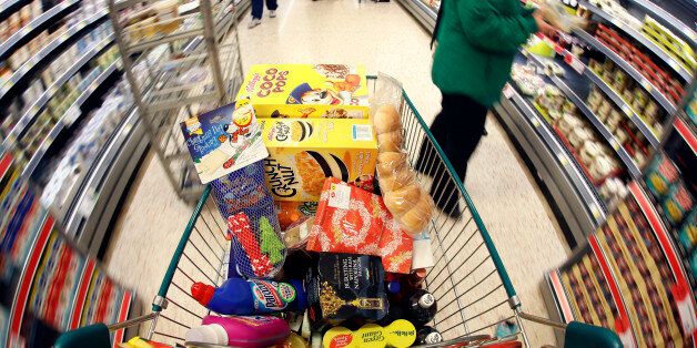 A shopping cart laden with groceries is pushed through the aisle in this arranged photograph at a Morrisons supermarket in Chadderton, U.K., on Monday, Dec. 17, 2012. The British Christmas is the biggest epicurean occasion of the year, with households spending a total of 4 billion pounds on food in the final week before Dec. 25. Photographer: Paul Thomas/Bloomberg via Getty Images