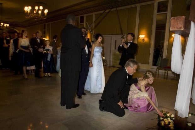 COLORADO SPRINGS, CO - MAY 16: Fathers accompany their daughters as they place a white rose representing purity at the foot of the cross on May 16, 2008 in Colorado Springs, Colorado. The annual Father-Daughter Purity Ball, founded in 1998 by Randy and Lisa Wilson, focuses on the idea that a trustworthy and nurturing father will influence his daughter to lead a lifestyle of 'integrity and purity.' (Photo by Marvi Lacar/Getty Images)