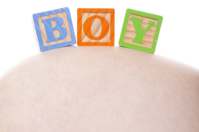 Blocks spelling Boy over mothers tummy.