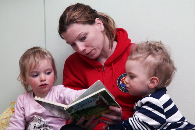 Mum mother reads reading to her children toddlers boy girl baby babies model released