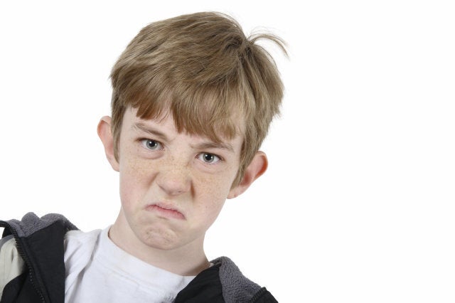 Sour expression on a very grumpy kid.