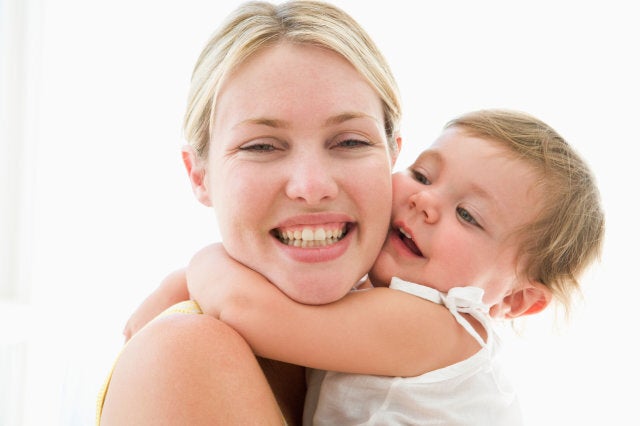 Mother and baby hugging and smiling