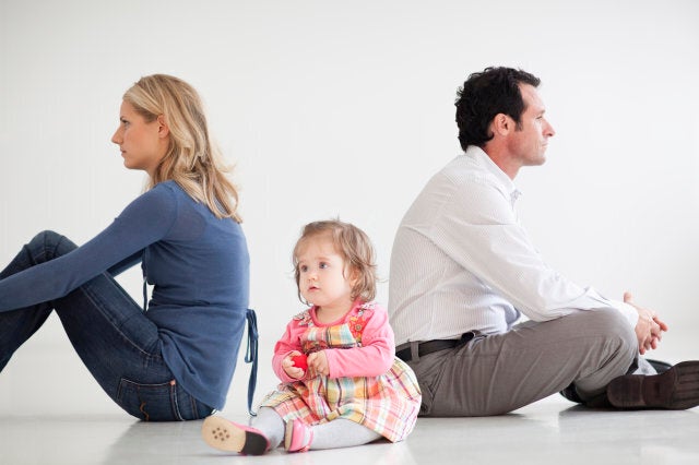 Upset couple sitting with baby girl