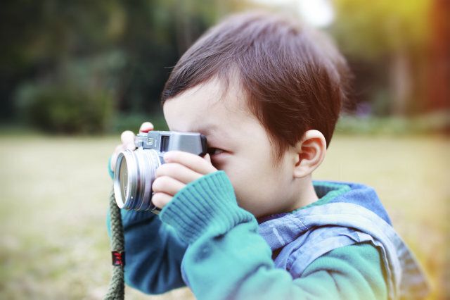 cute child plays the photographer