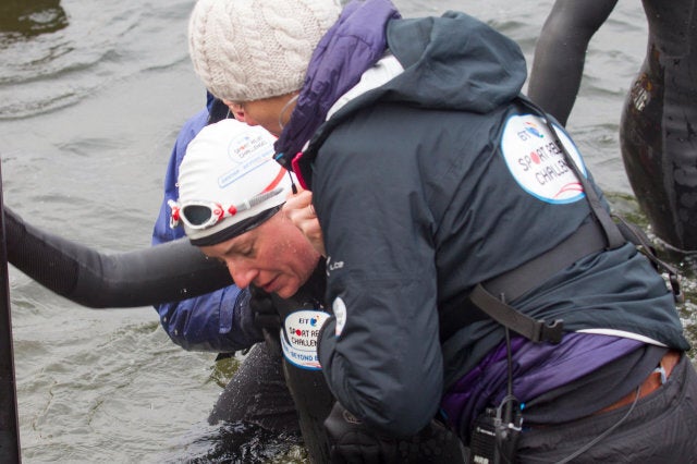 Windermere, Cumbria, UK. 10th February 2013. Windermere, Cumbria, UK. 10th February, 2014. Davina McCall Sport Relief challenge DAY 3 Davina McCall -Having collapsed after swimming across Lake Windermere being helped of the lake Davina - Beyond Breaking Point Starts the day swimming across Lake Windermere Landing at the Low Wood Bay Marina, on Lake Windermere, Lake District National park Davina McCall is running, swimming and cycle over 500 miles, from Edinburgh to London, in just seven days for Sport Relief© Shoosmith Collection/Alamy Live News